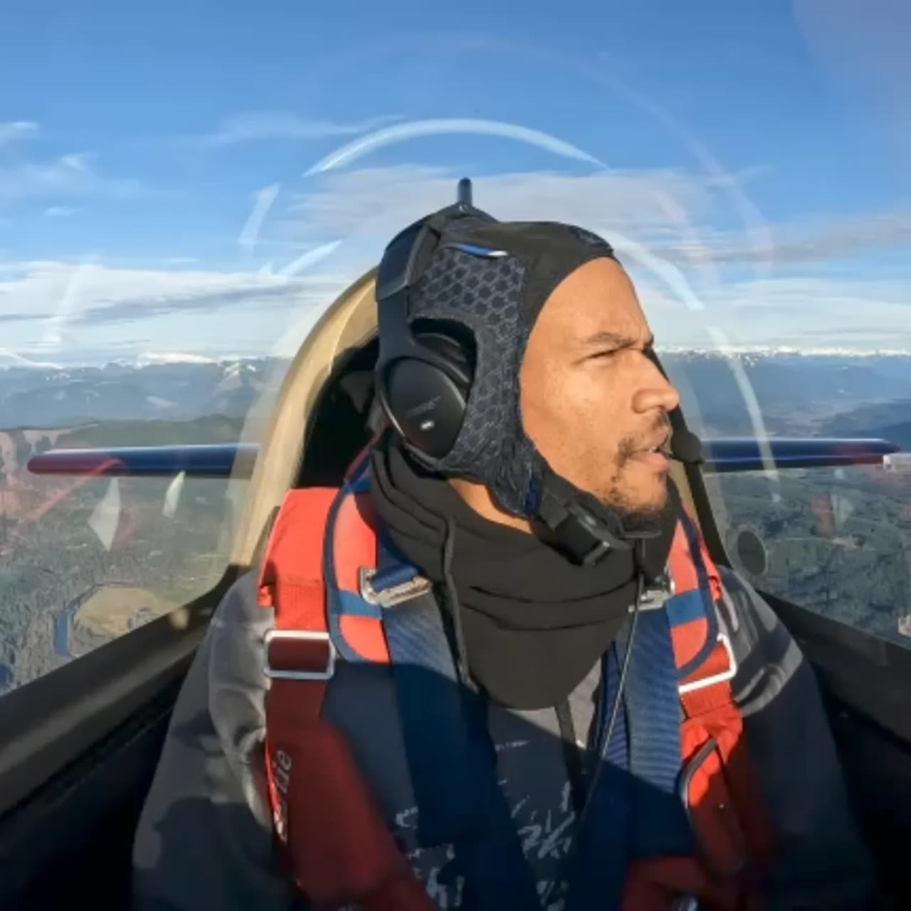 Doug Byrd in the cockpit of an Extra 300L wearing a flight headset.